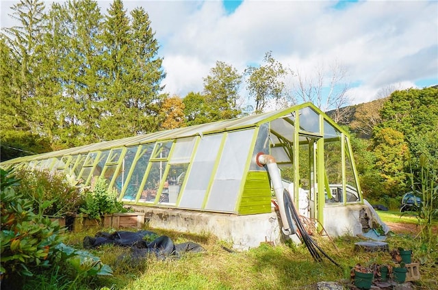 265 Main St, Delhi, NY 13753 - view of home's exterior with an outbuilding and a greenhouse