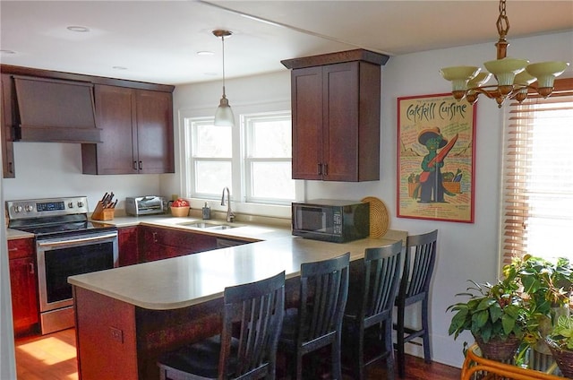 265 Main St, Delhi, NY 13753 - kitchen featuring a peninsula, premium range hood, black microwave, a sink, and electric range