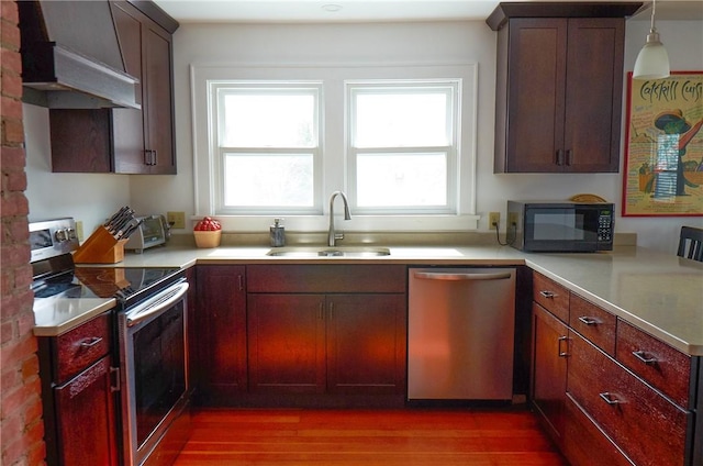 265 Main St, Delhi, NY 13753 - kitchen with light countertops, a sink, appliances with stainless steel finishes, dark wood finished floors, and custom range hood