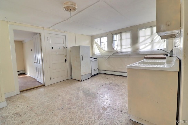 kitchen with light countertops, white appliances, baseboard heating, light floors, and a baseboard heating unit