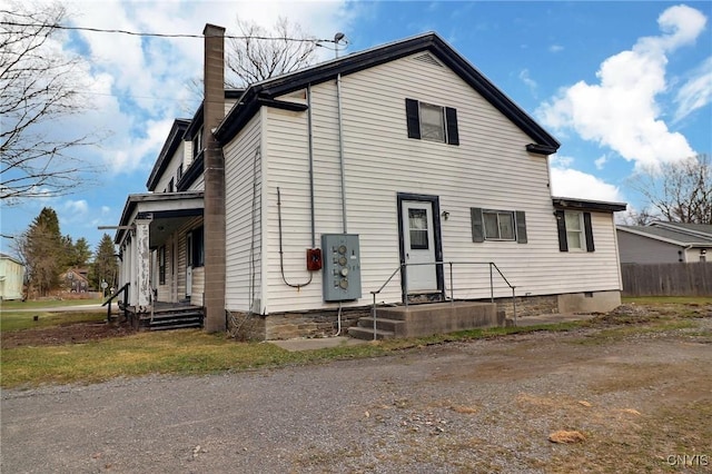 view of front of property with fence and a chimney