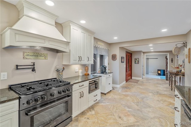20 Youman Rd, Constantia, NY 13028 - kitchen featuring appliances with stainless steel finishes, premium range hood, baseboards, dark stone countertops, and recessed lighting