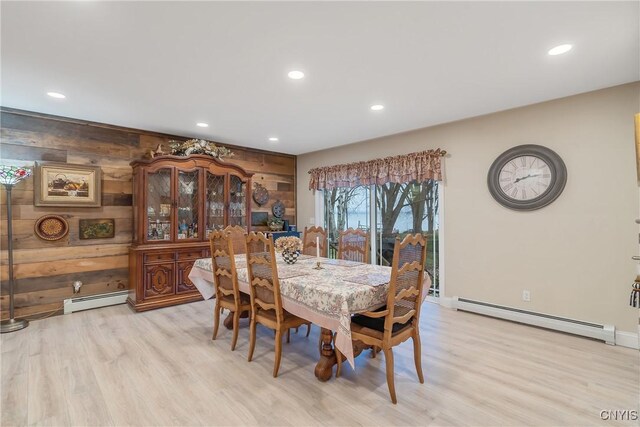 20 Youman Rd, Constantia, NY 13028 - dining space featuring a baseboard radiator, light wood-style flooring, recessed lighting, wood walls, and baseboards
