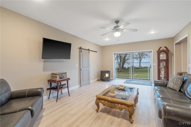 20 Youman Rd, Constantia, NY 13028 - living room featuring a wood stove, ceiling fan, light wood-style flooring, baseboards, and recessed lighting