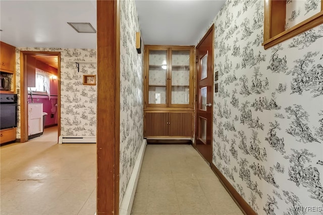 11765 Maple Ridge Rd, Shelby, NY 14103 - hallway featuring baseboards, wallpapered walls, and a baseboard heating unit