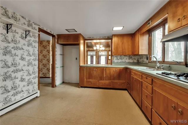 11765 Maple Ridge Rd, Shelby, NY 14103 - kitchen featuring light countertops, a sink, a chandelier, baseboard heating, and brown cabinetry