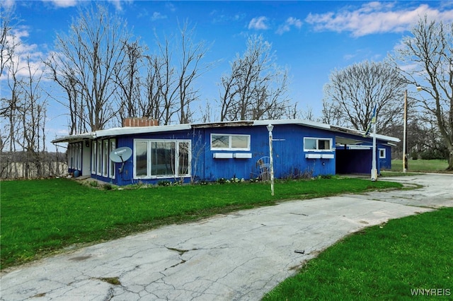 11765 Maple Ridge Rd, Shelby, NY 14103 - view of property exterior featuring a chimney, concrete driveway, and a yard