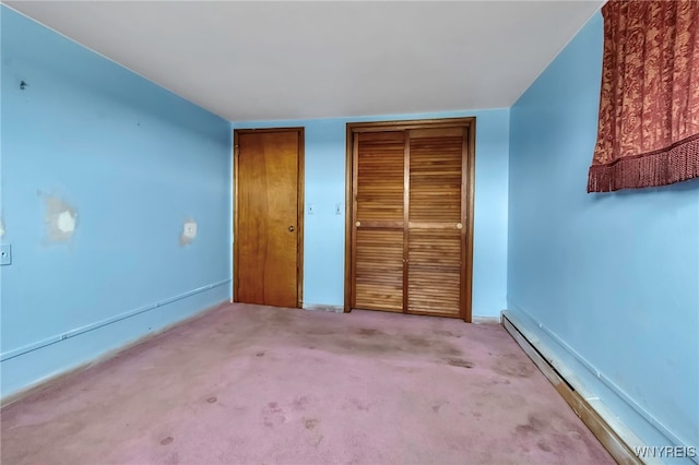 11765 Maple Ridge Rd, Shelby, NY 14103 - unfurnished bedroom featuring baseboard heating and carpet flooring