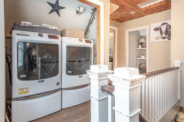 laundry room with wood ceiling, laundry area, wood finished floors, and washer and dryer