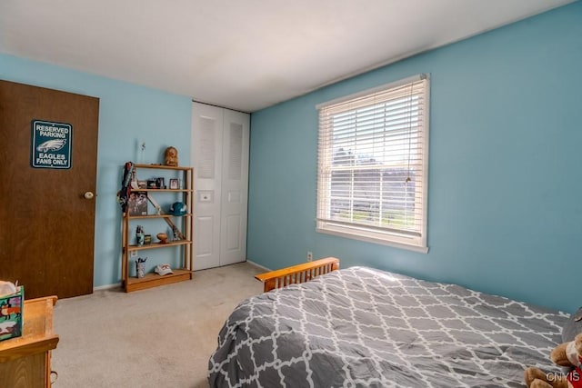 bedroom with carpet, a closet, and baseboards