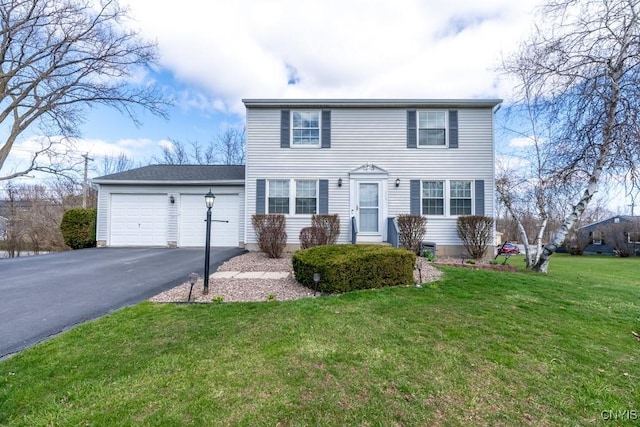 view of front of house with a front lawn, driveway, and a garage