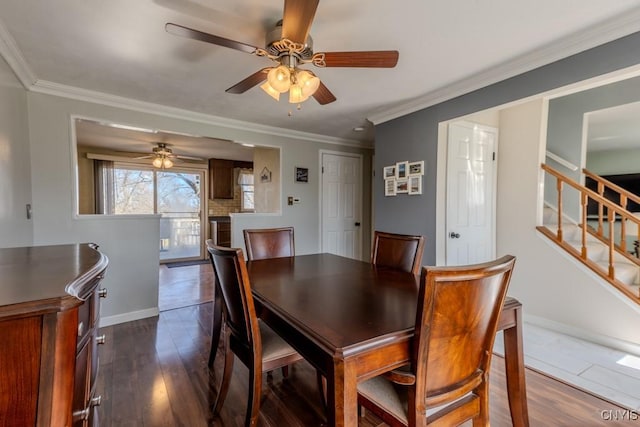 dining room with dark wood-type flooring, ceiling fan, baseboards, and stairway