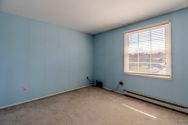 carpeted spare room featuring baseboard heating