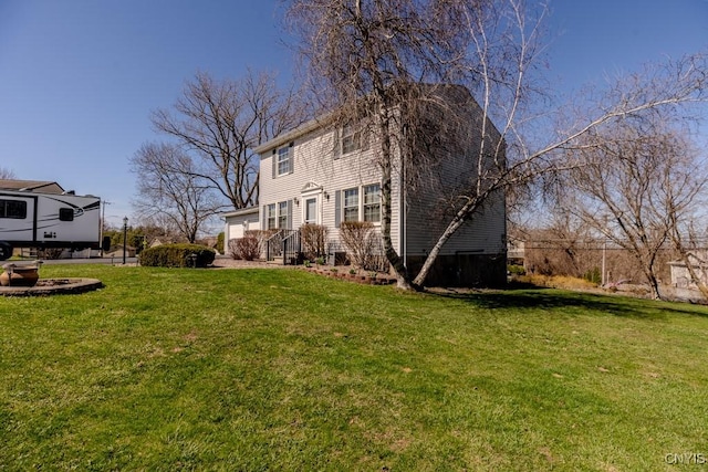 rear view of property featuring a yard