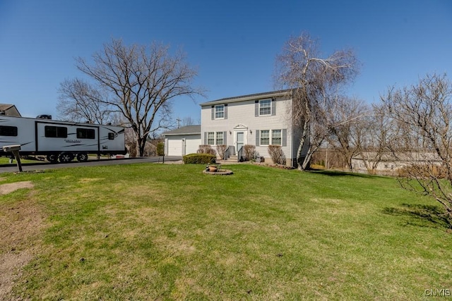view of front facade with a front yard and aphalt driveway