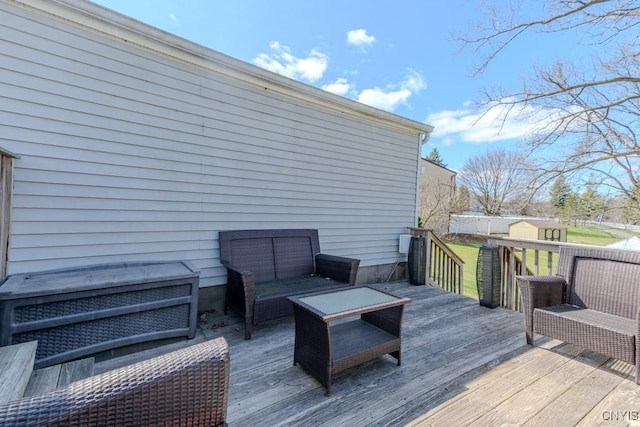 deck with an outdoor living space and an outdoor structure