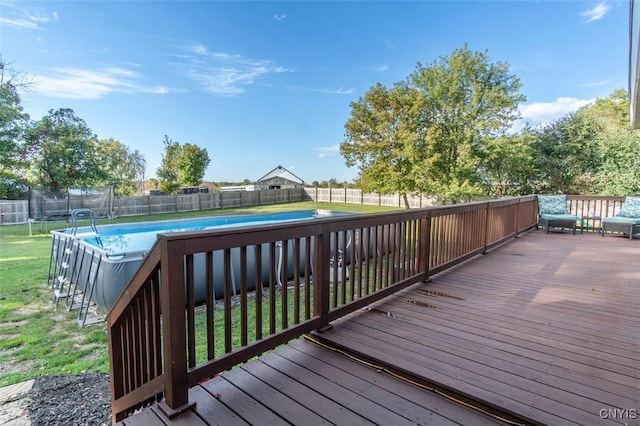 4973 Wilder Rd, Ellisburg, NY 13605 - deck featuring a trampoline, a fenced backyard, a fenced in pool, and a lawn