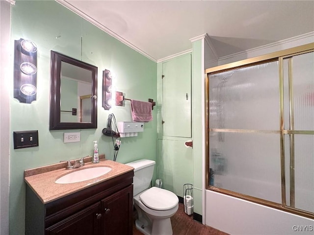 bathroom with toilet, vanity, combined bath / shower with glass door, and crown molding