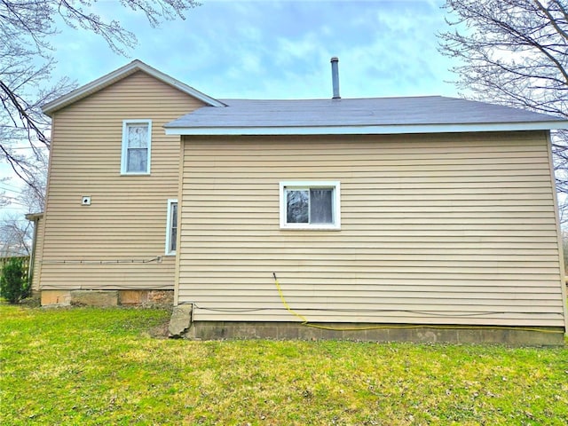 view of side of home featuring a lawn