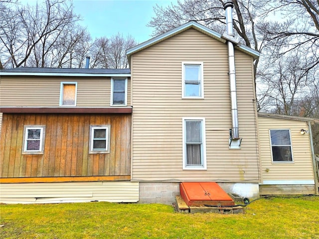 rear view of property with a lawn