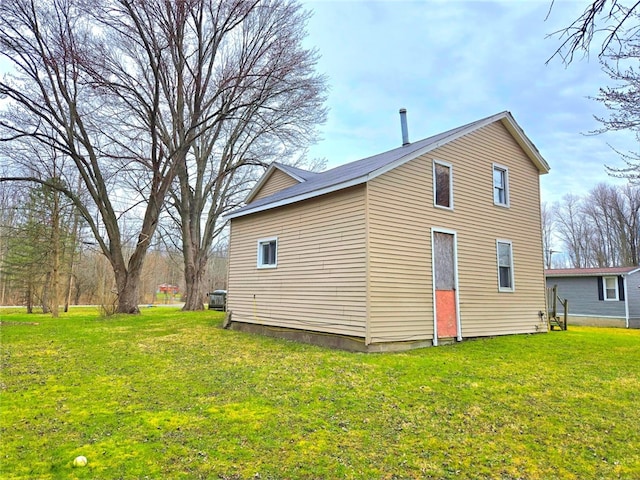 back of property featuring a yard