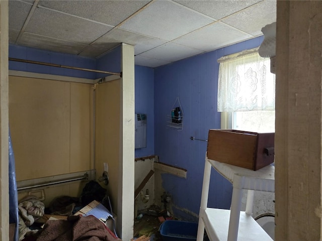 interior space with a paneled ceiling
