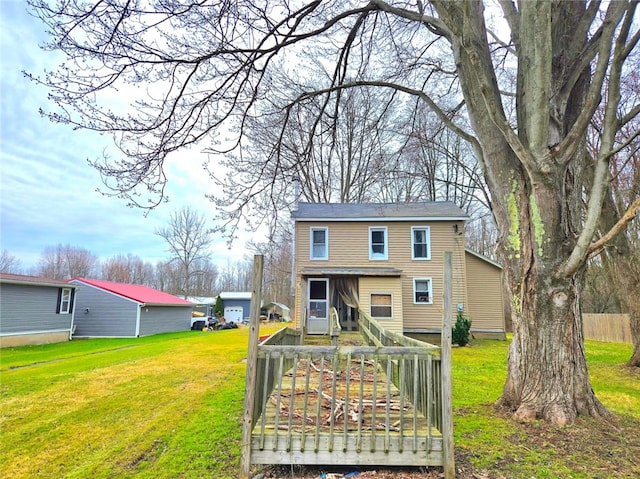 view of front of home with a wooden deck and a front yard
