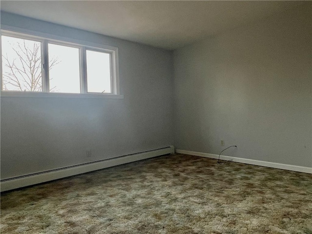 spare room featuring a baseboard radiator, carpet flooring, and baseboards