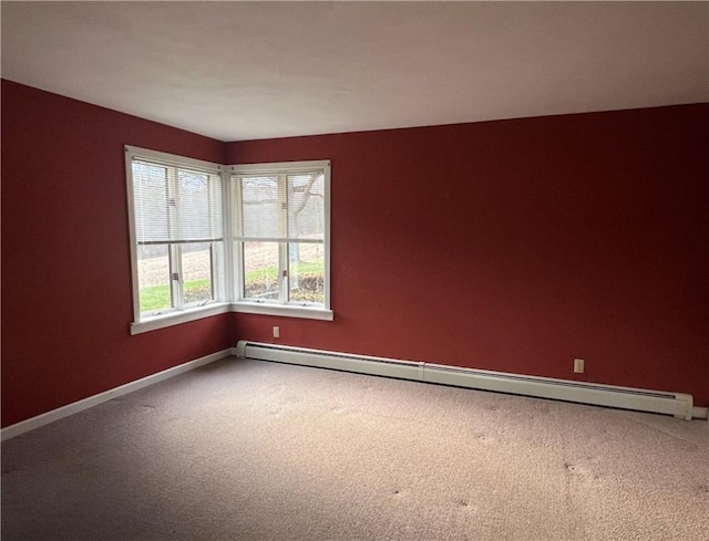 carpeted empty room featuring baseboards and a baseboard heating unit