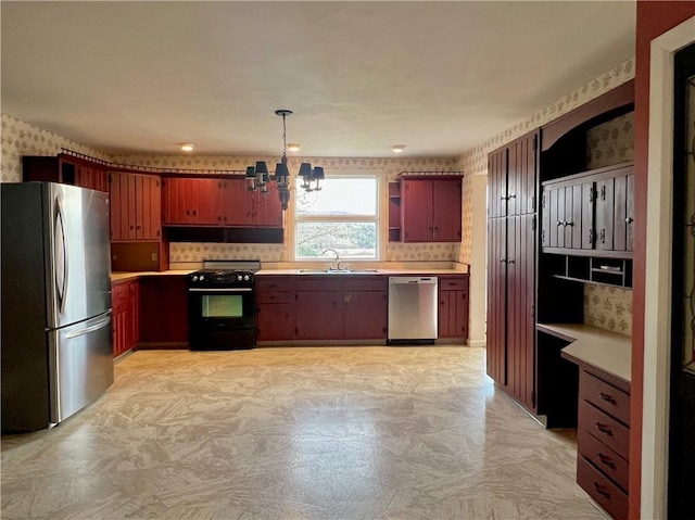 kitchen featuring a notable chandelier, a sink, open shelves, stainless steel appliances, and wallpapered walls