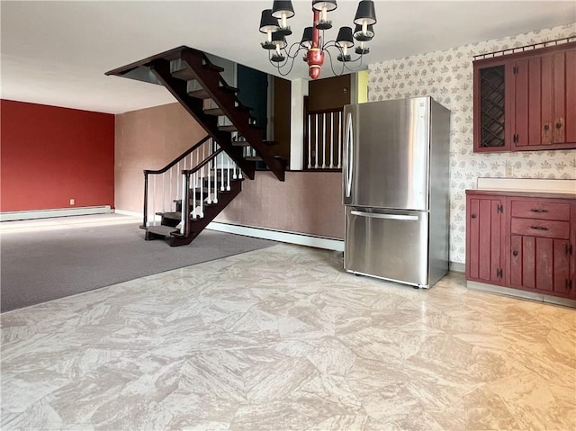 kitchen with freestanding refrigerator, a baseboard radiator, wallpapered walls, a baseboard heating unit, and an inviting chandelier