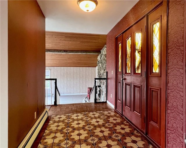 entrance foyer with a baseboard radiator, tile patterned floors, and baseboards