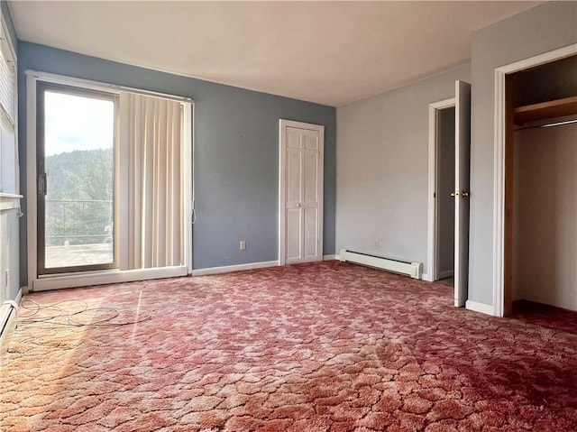 unfurnished bedroom featuring baseboards, multiple closets, a baseboard heating unit, and carpet