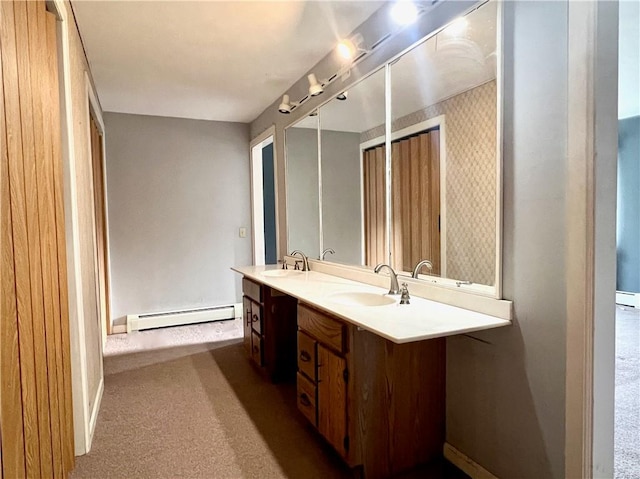 full bath featuring double vanity, a sink, wallpapered walls, and a baseboard radiator