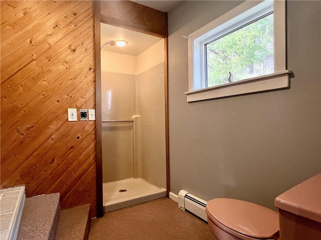 full bath with toilet, baseboard heating, a shower, and wood walls