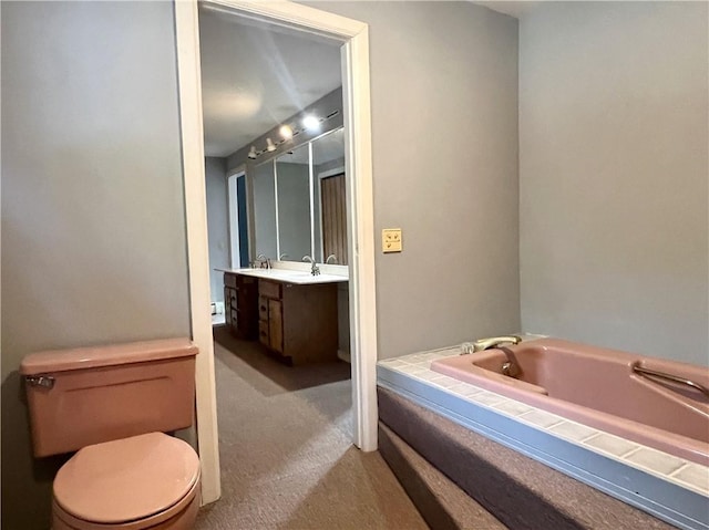 bathroom featuring a bath, toilet, and vanity