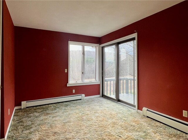 carpeted empty room with baseboards and a baseboard radiator