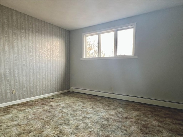 carpeted empty room with baseboards and a baseboard radiator