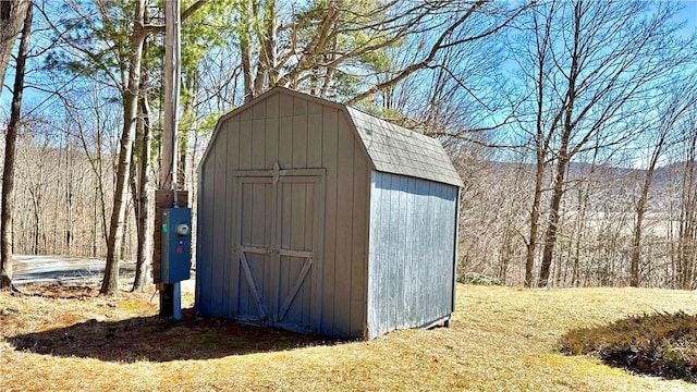 view of shed with a view of trees