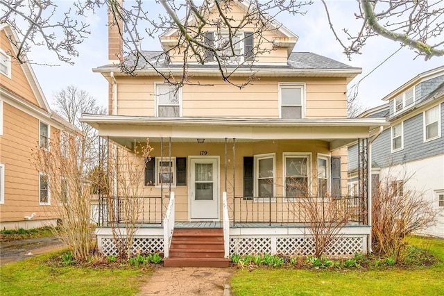 179 S W St, Geneva-City, NY 14456 - traditional style home featuring a chimney, a front lawn, a porch, and roof with shingles