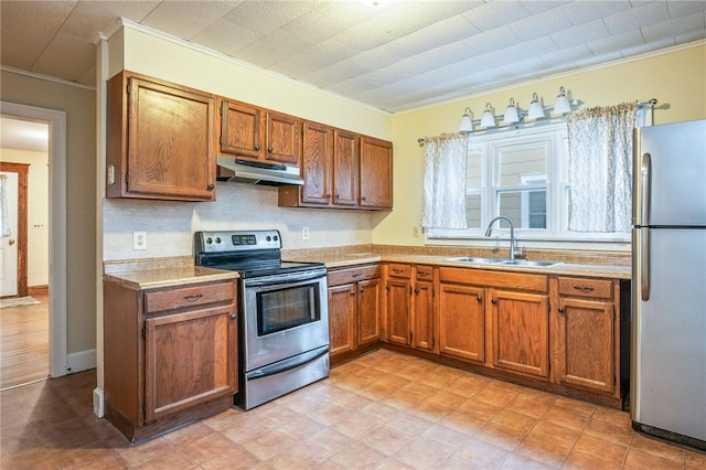 179 S W St, Geneva-City, NY 14456 - kitchen with light countertops, stainless steel appliances, under cabinet range hood, a sink, and brown cabinets