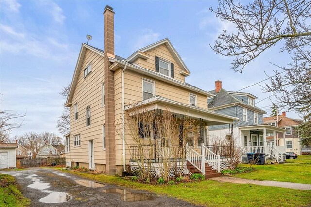 179 S W St, Geneva-City, NY 14456 - traditional style home featuring covered porch, a chimney, aphalt driveway, and a front lawn