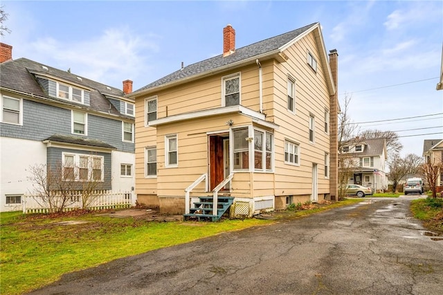 179 S W St, Geneva-City, NY 14456 - back of property featuring a chimney, driveway, and entry steps