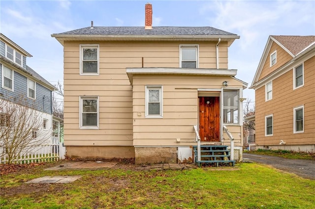 179 S W St, Geneva-City, NY 14456 - view of front of property with entry steps, a front lawn, and a chimney