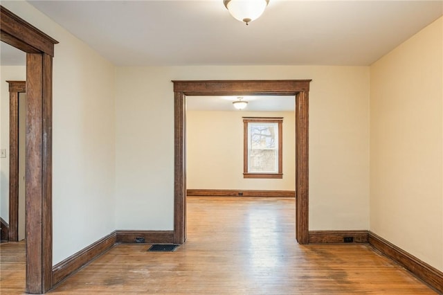 179 S W St, Geneva-City, NY 14456 - unfurnished room with baseboards, visible vents, and wood finished floors