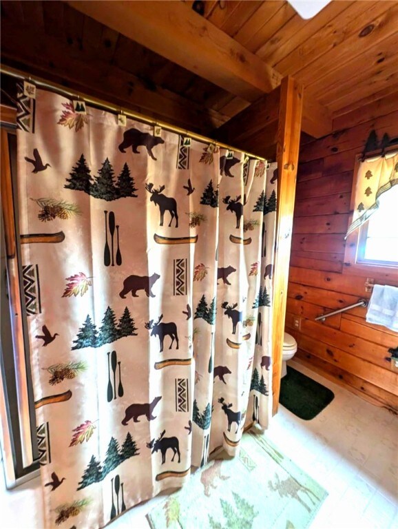 7061 Velie Rd, Bath, NY 14879 - full bathroom with toilet, wooden ceiling, wood walls, and curtained shower
