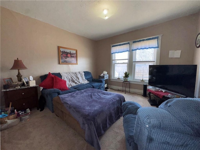 bedroom featuring carpet flooring and baseboards