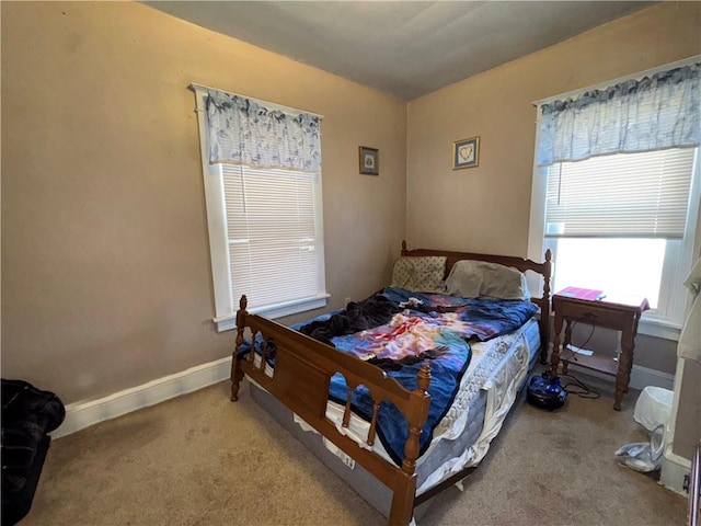 bedroom featuring baseboards and carpet flooring