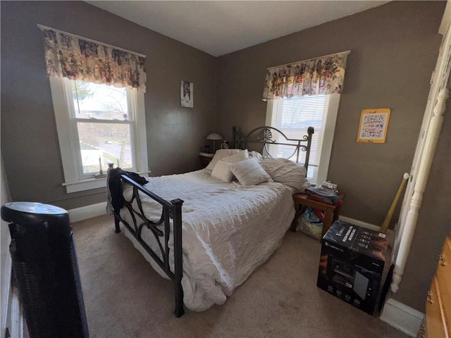 carpeted bedroom featuring baseboards