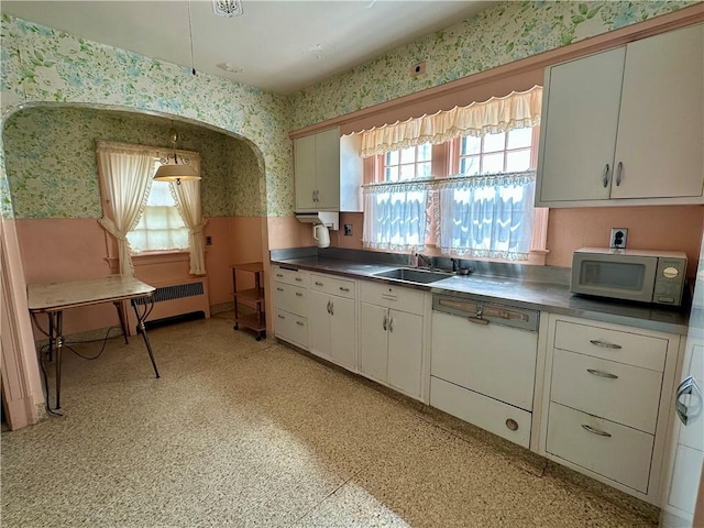 174 N Bennett St, Bradford-City, PA 16701 - kitchen with wallpapered walls, white appliances, a sink, radiator, and white cabinetry